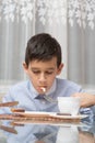 Boy eating soup at the kitchen table Royalty Free Stock Photo