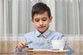 Boy eating soup at the kitchen table Royalty Free Stock Photo