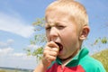 Boy eating sour fruit Royalty Free Stock Photo