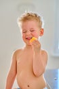 Boy eating sour fruit Royalty Free Stock Photo
