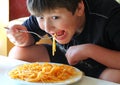 Boy eating spaghetti