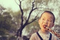 Boy eating sugarcoated haws