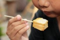 The boy eating toast topped with almonds and honey. Royalty Free Stock Photo