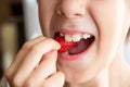 Boy eating a very tasty strawberry on a light background. Close up Royalty Free Stock Photo