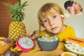 Boy eats fruit but dreams about hamburger. Harmful and healthy food for children. Child eating healthy snack. Vegetarian Royalty Free Stock Photo