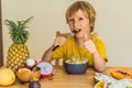 Boy eats fruit. Healthy food for children. Child eating healthy snack. Vegetarian nutrition for kids. Vitamins for Royalty Free Stock Photo