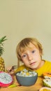 Boy eats fruit. Healthy food for children. Child eating healthy snack. Vegetarian nutrition for kids. Vitamins for Royalty Free Stock Photo