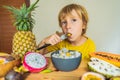 Boy eats fruit. Healthy food for children. Child eating healthy snack. Vegetarian nutrition for kids. Vitamins for