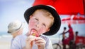A Boy Eats an Ice Lolly on a Sunny Beach Royalty Free Stock Photo