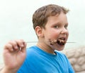 Boy eats kebab on a stick Royalty Free Stock Photo