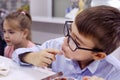 Savoring Flavor: A Young Boy Delights in Fast Food Royalty Free Stock Photo