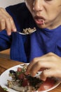 boy eats vegetable salad with a fork, Royalty Free Stock Photo