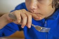 boy eats vegetable salad with a fork, covering Royalty Free Stock Photo