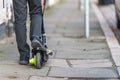 Boy on electrical scooter driving to British school in UK