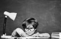 Boy from elementary school at the school yard. Cheerful smiling child at the blackboard. Science education concept.