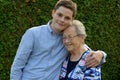 Boy embraces lovingly his great-grandma