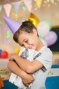 Boy embracing gift box during birthday party