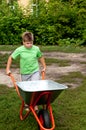 Boy with the empty wheelbarrow Royalty Free Stock Photo