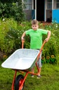 Boy with the empty wheelbarrow Royalty Free Stock Photo