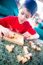 Boy engross on the wooden jigsaw game.