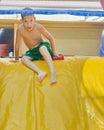 Boy enjoying a wet inflatable slide Royalty Free Stock Photo