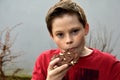 Boy enjoys chocolate pastry with nuts Royalty Free Stock Photo