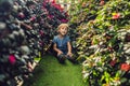 A boy enjoys flowers in a flower greenhouse