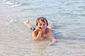 Boy enjoys lying at the beach in the surf Royalty Free Stock Photo