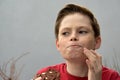 : Boy enjoys a piece of chocolate pastry Royalty Free Stock Photo