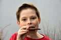 Boy enjoys chocolate pastry with nuts Royalty Free Stock Photo