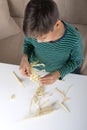 The boy with enthusiasm collects a skeleton of a dinosaur Royalty Free Stock Photo