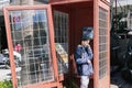 boy of European appearance in telephone booth is talking on the phone Royalty Free Stock Photo