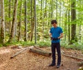 Boy examining the GPS device on trail Royalty Free Stock Photo