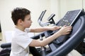 Boy exercising at stride treadmill Royalty Free Stock Photo