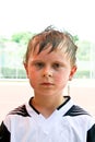 Boy with sweaty face and wet hair looks Royalty Free Stock Photo