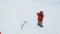 A boy exploring a frozen pond