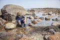 Boy exploring tide pools on New Hampshire coast