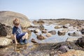 Boy exploring tide pools on New Hampshire coast Royalty Free Stock Photo