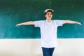 Boy extend the arms with book on head, standing before chalkboard, punishing Royalty Free Stock Photo