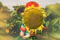 Boy face behind sunflower Royalty Free Stock Photo
