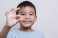 boy face looking at tooth and showing teeth behind on white background Royalty Free Stock Photo