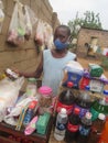 Child wearing facemask selling goods at a backyard grocery stall