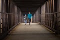 Hispanic Brothers Having Fun Running Together on A Bridge