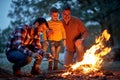 Boy with father and grandfather enjoying in campfire