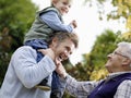 Boy With Father And Grandfather Enjoying In Park