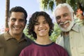 Boy (13-15) with Father and Grandfather outdoors front view portrait.