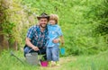 Boy and father in nature with watering can. Spring garden. Dad teaching little son care plants. Little helper in garden Royalty Free Stock Photo