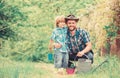 Boy and father in nature with watering can. Spring garden. Dad teaching little son care plants. Little helper in garden Royalty Free Stock Photo