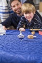 Boy with father spinning dreidel Royalty Free Stock Photo