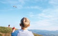 Boy and father start to fly a kite in sky over mountain hills Royalty Free Stock Photo